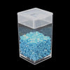 A clear storage box filled with small, light blue diamond painting tiles and organized by trays.
