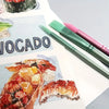A watercolor painting of a food item next to a green brush and a pink brush on white paper.