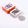 A red box containing a portable mini playing cards set and a silver coin.