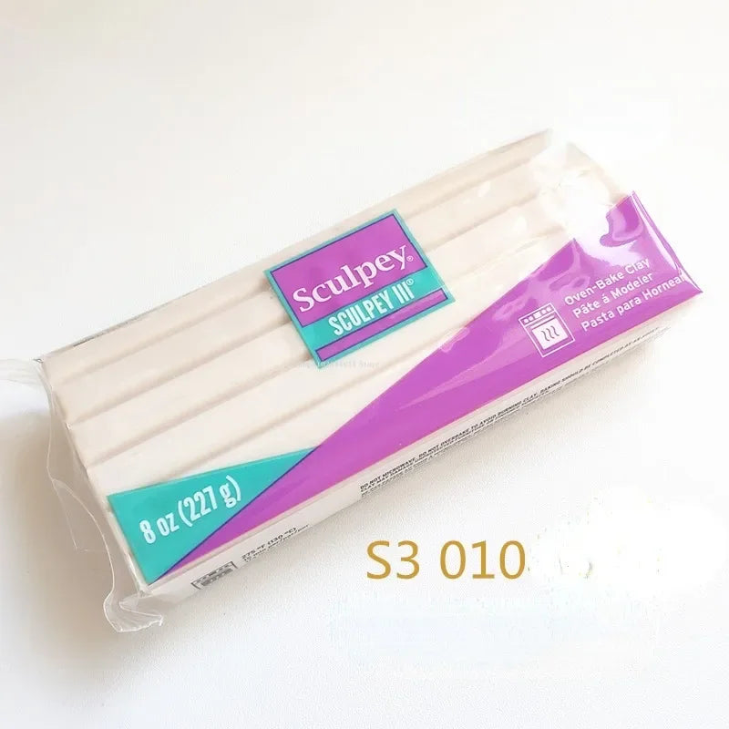 A plastic package of Sculpey III oven-bake clay in a purple and teal design.