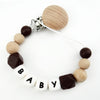 A necklace featuring wooden and silicone teething beads attached to a clip, designed as a personalized pacifier accessory.