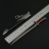 A replica Orcrist sword model next to a ruler showing its length.
