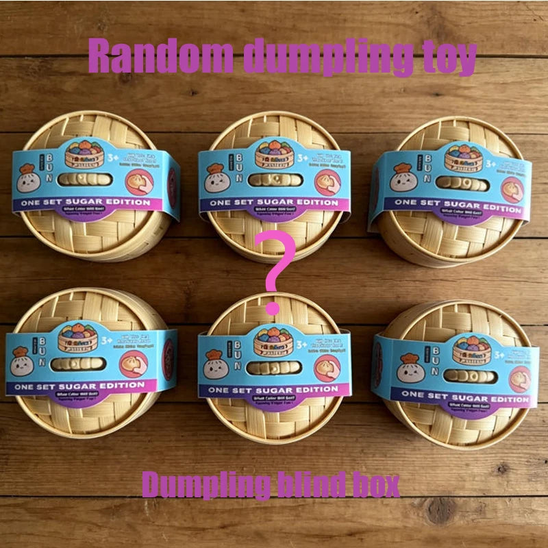 A collection of random dumpling toys packaged in boxes on a wooden surface.