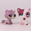 A pink and white shorthair cat bobble head figurine with large eyes and pink accents.