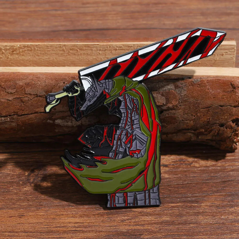 A lapel pin featuring a stylized green dragon head with red markings and a sword on a wooden surface.