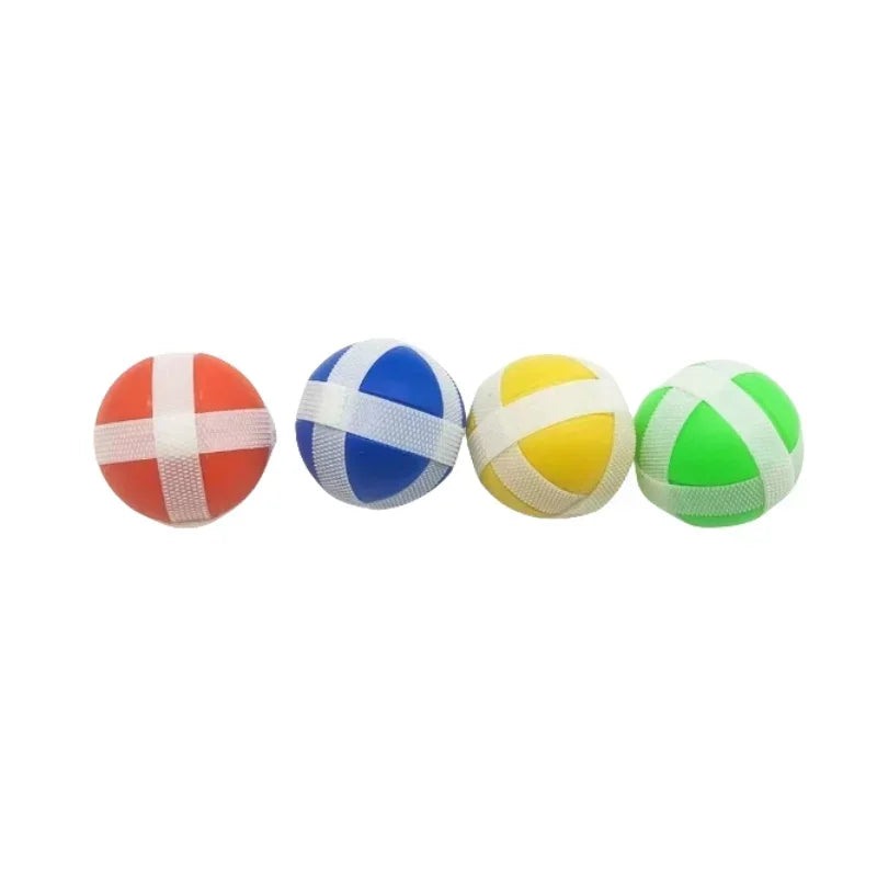 A set of four colored sticky balls used for target shooting games.