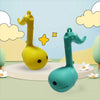 A yellow and teal Otamatone mini electronic musical instrument toy shaped like an elephant standing on a light green surface.
