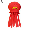 A bright red squeeze and soak octopus bath toy with yellow eyes and tentacles.