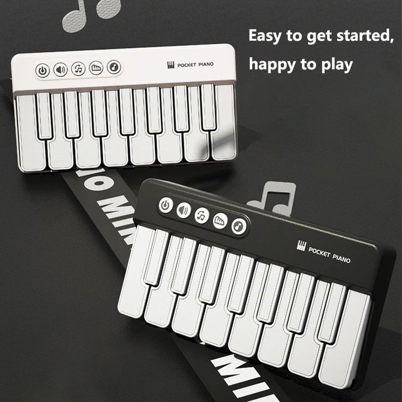 A white pocket piano keyboard is shown, featuring musical notes and controls, set against a dark background.