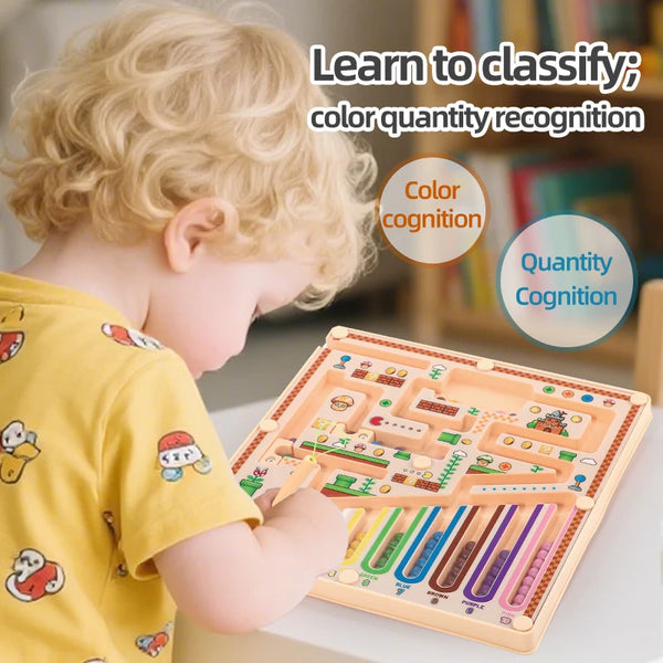 A young child is playing with a magnetic maze educational ball for color and quantity recognition.