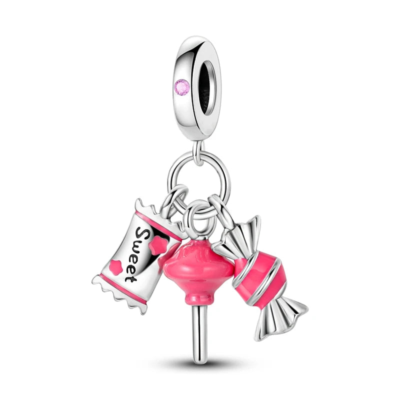A silver heart charm bead with a pink zircon gemstone and a bail for jewelry.