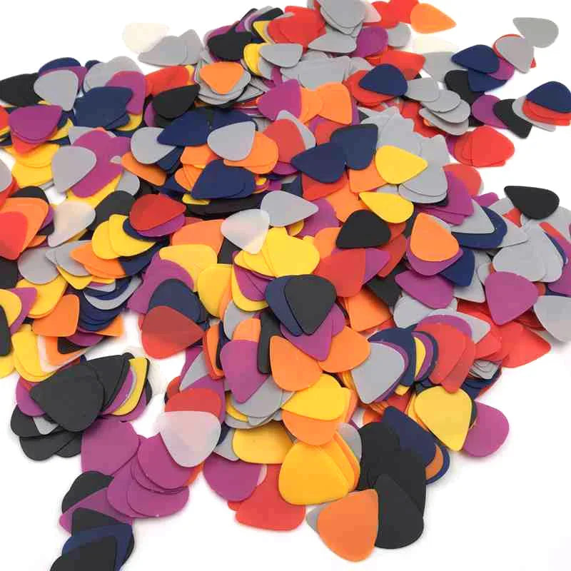 A pile of assorted colored celluloid guitar picks in various thicknesses.
