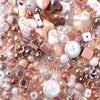 A close-up of colorful acrylic bow beads in various shades and shapes for DIY jewelry making.