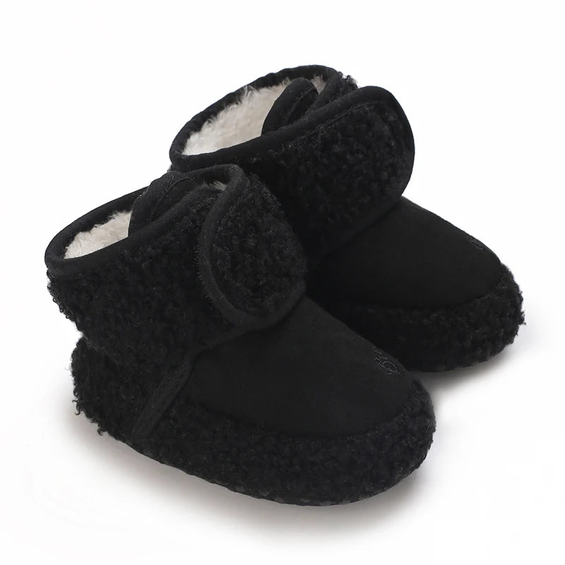 A pair of black plush baby snow boots with faux fur trim and anti-slip soles.
