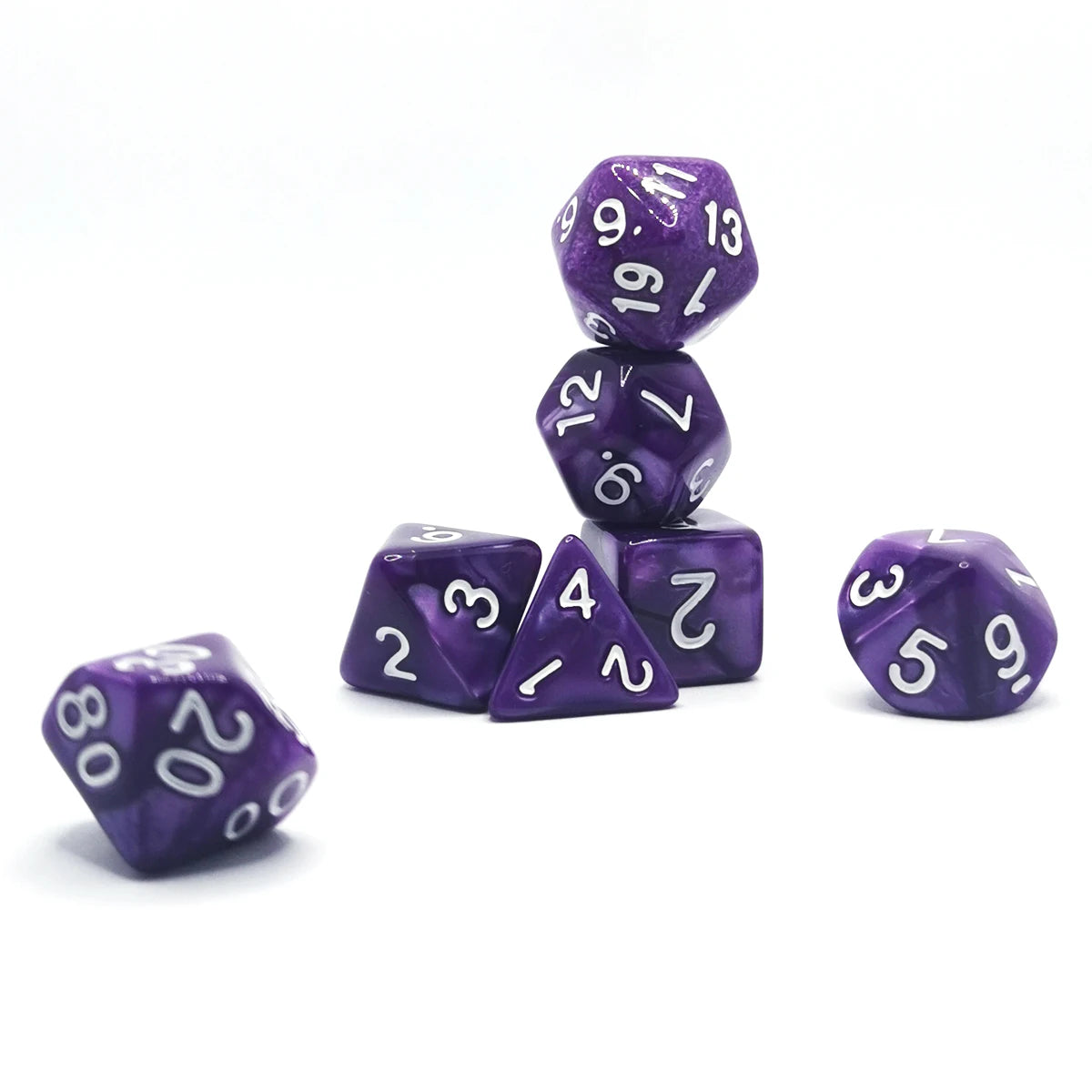 A stack of seven purple polyhedral dice, including d6s, d8s, and d10s, on a white surface.