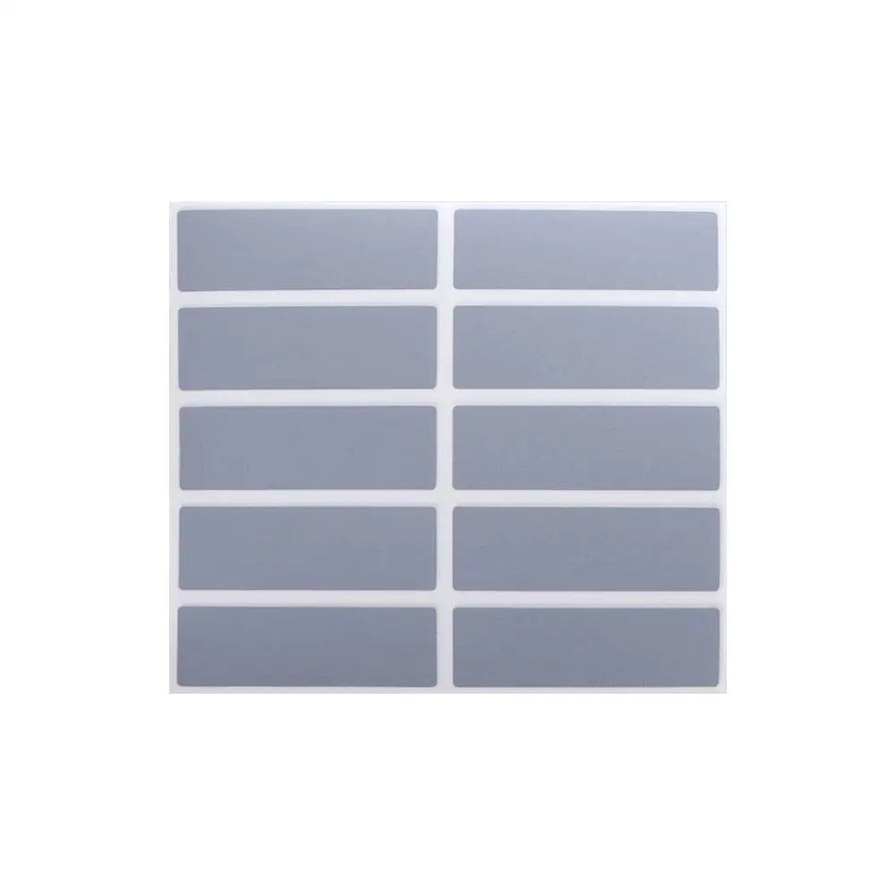 A sheet of square, translucent gray scratch-off sticker sheets for DIY cards and games.