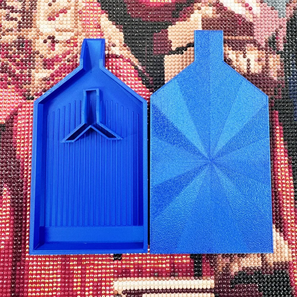 A bright blue large diamond painting tray with a pop-up plug for bead sorting placed on a colorful fabric background.