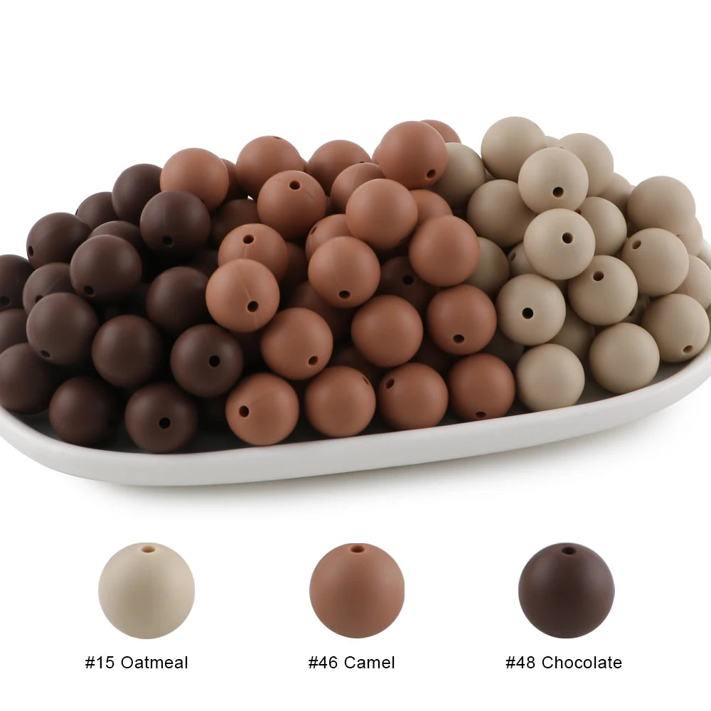 A collection of round silicone beads in various shades including oatmeal, camel, and chocolate.