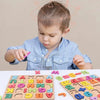 A young child is interacting with a colorful wooden alphabet and number puzzle.