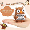A handmade crochet owl with large eyes sits in an open palm, surrounded by inspirational text.