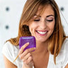 A woman holds a purple glitter ice cube sensory fidget toy in her hand.