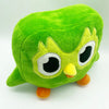 A soft green plush toy of Duo the Owl with large eyes and a yellow beak.