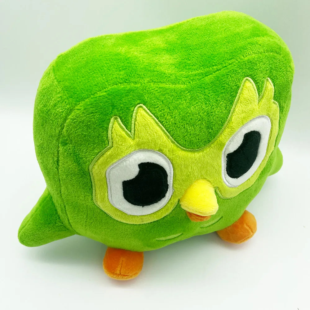 A soft green plush toy of Duo the Owl with large eyes and a yellow beak.
