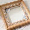 A wooden frame displaying fabric-textured sticker strips with small rabbit designs for journaling and scrapbooking.