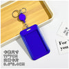 A royal blue rectangular ID badge holder with a keychain and clip displayed on a wooden tray.