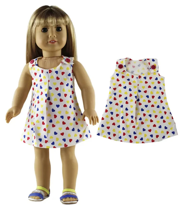 A doll wearing a white top with a colorful heart pattern and a matching skirt.