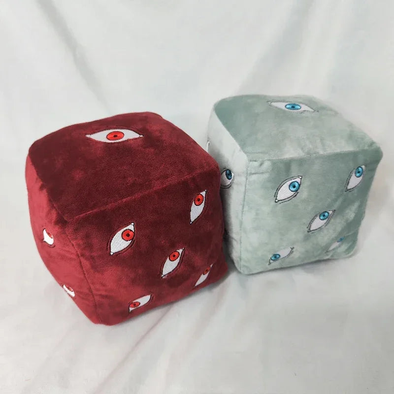 A pair of Jujutsu Kaisen Prison Realm Gojo plush figures, one red and one light green, both featuring eye designs.