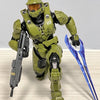 A 1/12 scale Master Chief action figure in olive green armor standing on a wooden surface.