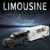 A black diecast model of a limousine-style RV camper truck is shown on a dark surface.