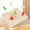 A wooden strategy chess game board with pieces in green and red colors on a light wood surface.