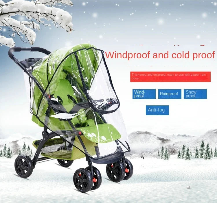 A green and black stroller with a transparent waterproof cover is shown in a snowy outdoor setting.