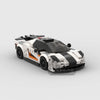 A detailed model of a classic supercar built from building blocks, featuring white and black paint schemes.