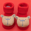 Pair of red baby anti-slip cotton socks with festive Christmas designs featuring cute bear faces