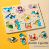 A wooden animal shape matching puzzle board featuring various sea creatures like whales, sharks, and sea turtles.