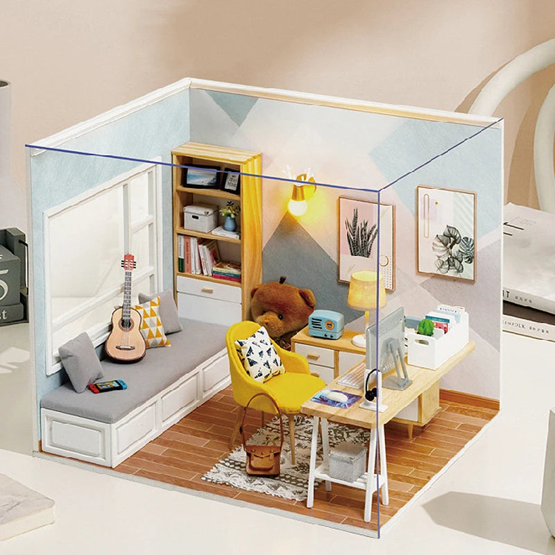 A DIY wooden miniature dollhouse kit featuring a yellow chair, wooden furniture, and decorative elements displayed within a c