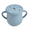A light blue silicone snack cup with a lid and handle, featuring a decorative heart design.