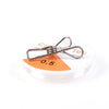 A silver realistic snake prank toy with a string and clip is shown next to a white disc marked 0.5.