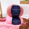 Pink YEDAN MERINO wool thread skeins with labels showing anti-pilling and non-fading features