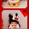 A cute Monchhichi plush keychain in yellow and white with an orange collar and pink accents.