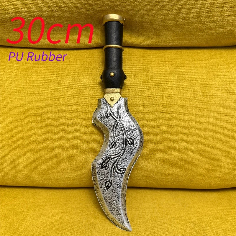 A silver sawtooth dagger knife prop with a black handle is displayed on a yellow fabric background.