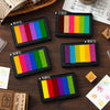 A set of six large rectangular rainbow gradient ink pads for stamping and crafts displayed on a wooden surface.