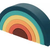A rainbow-colored arc or arch shape made of soft silicone building blocks.