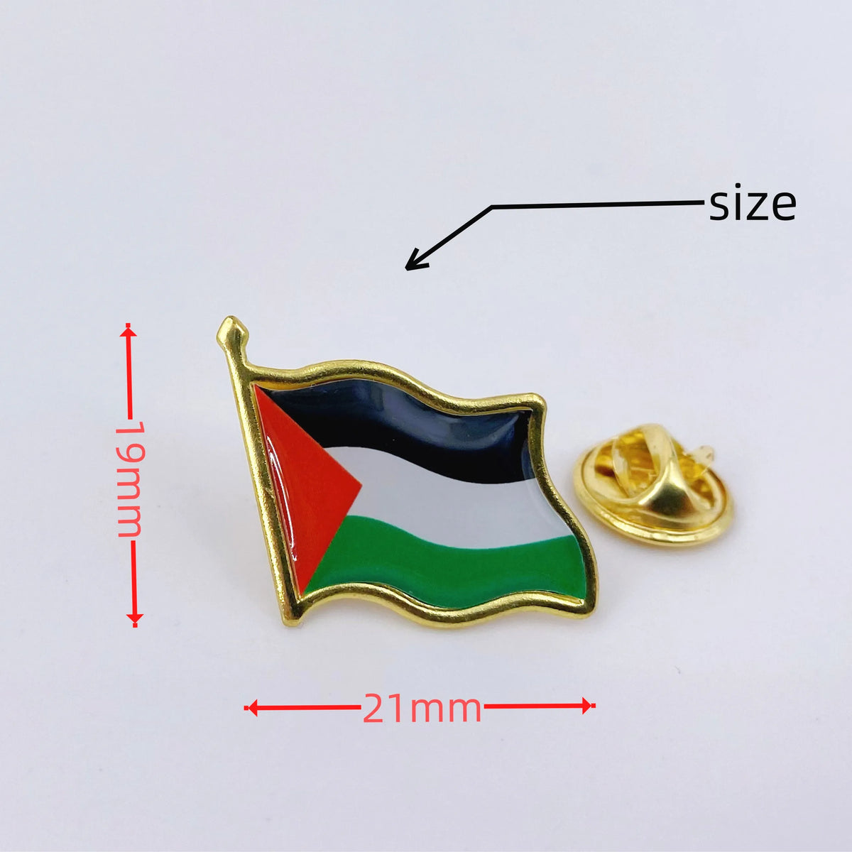 A gold lapel pin featuring the flag of Palestine with red, black, white, and green stripes.