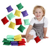 A smiling toddler sits surrounded by ten colorful mini bean bags in various shades of green, yellow, purple, and red.