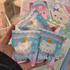 A hand holds several cute mini bean blind box figurines featuring an octopus cat pendant charm and strawberry mousse tower de