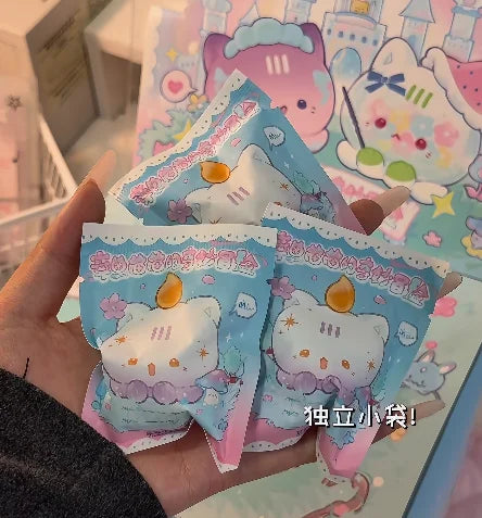A hand holds several cute mini bean blind box figurines featuring an octopus cat pendant charm and strawberry mousse tower de